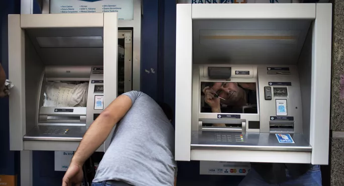 Men fixing ATM cash machines