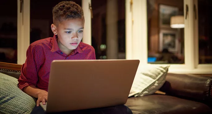 Safeguarding child watching laptop