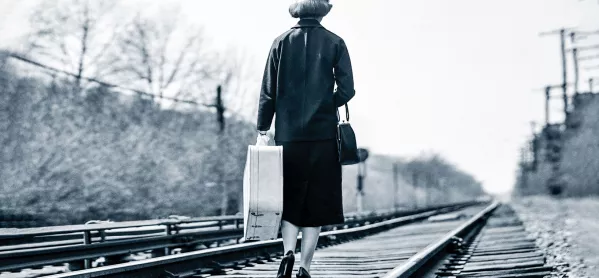 Woman walking train tracks