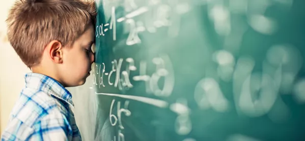 Child facing a blackboard