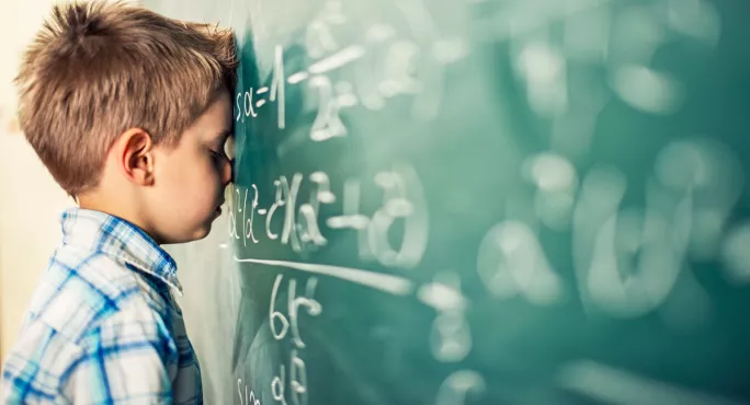 Child facing a blackboard