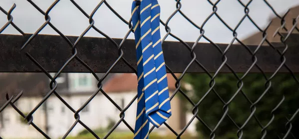 School leavers tie on fence
