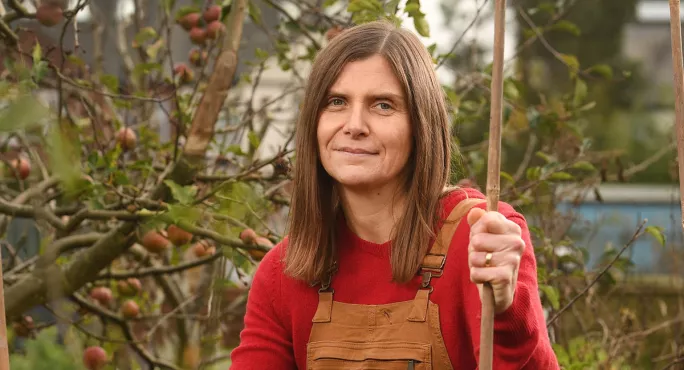 Melanie Renowden in dungarees in allotment