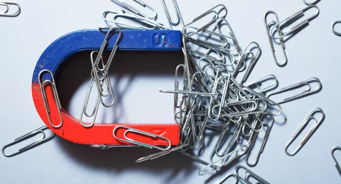 Magnet covered in paperclips