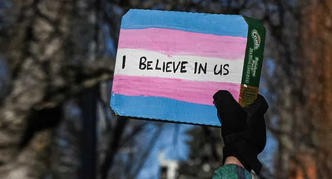 I believe in us sign on transgender flag