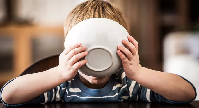 Pupil with face covered by bowl