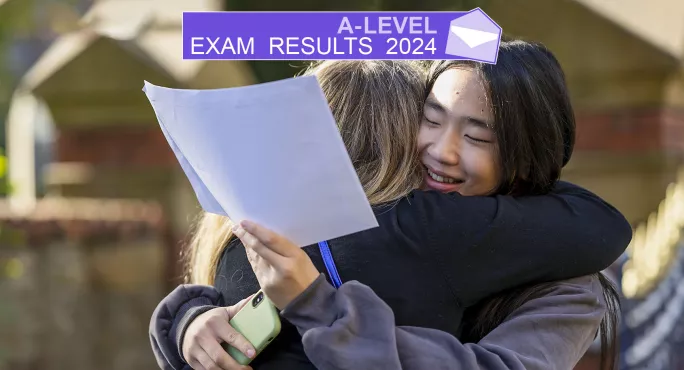 Two students receiving A-level exam results at school