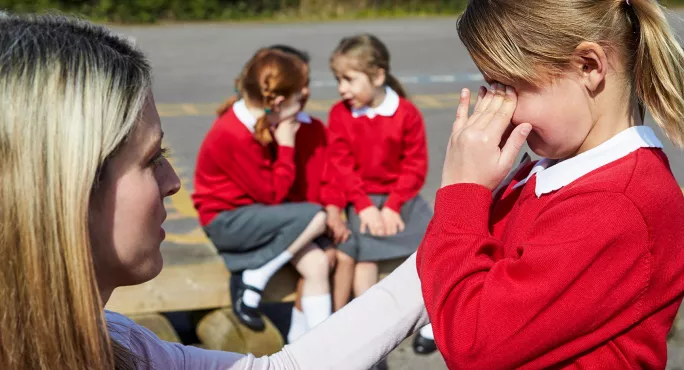 Comforting little girl pupil