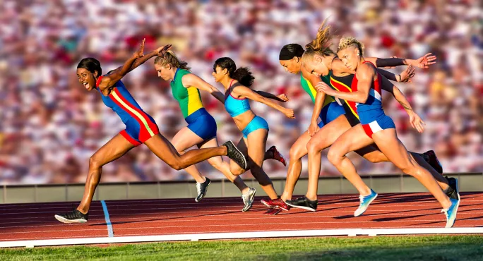 Women sprinters crossing the finish line