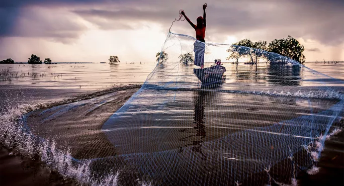 fisherman casting net in Thailand