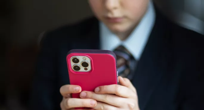 child on phone with red case