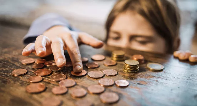 A child counting coins