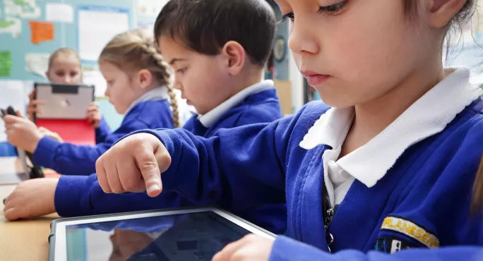 A picture of children using assistive technology in school