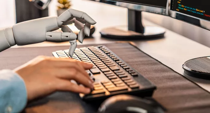 Human and robot hands using keyboard