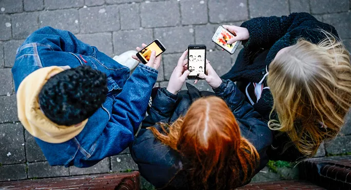 School children with mobile phones