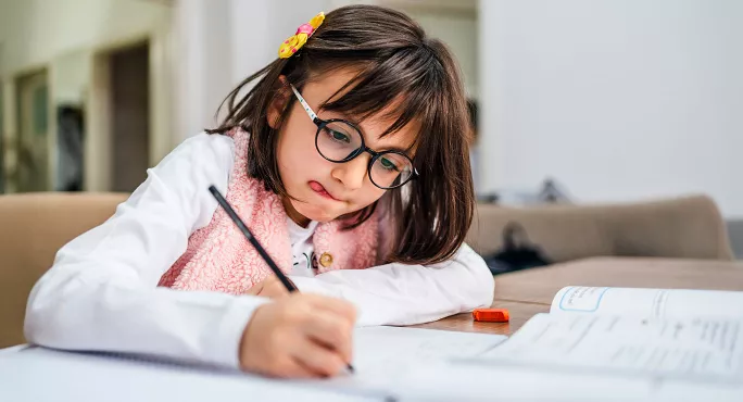 Child concentrating while writing