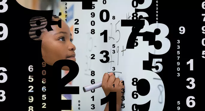 Girl working out sum on whiteboard