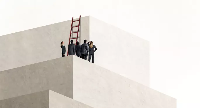 A small group of people trying to climb a wall using a ladder