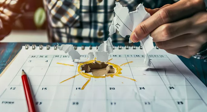 Sun shining from torn calendar