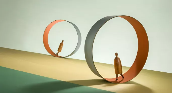 Two people walking in hamster wheel