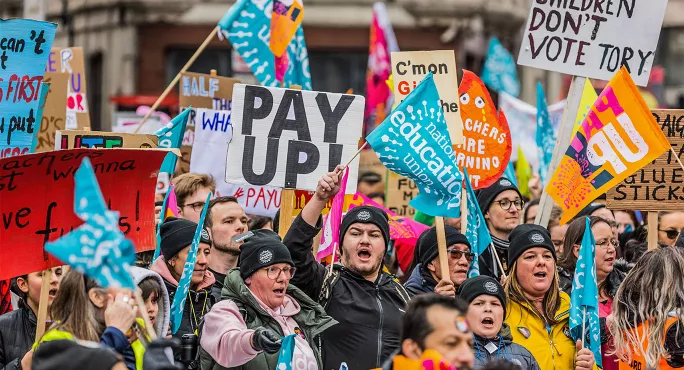 NEU members on strike holding placards