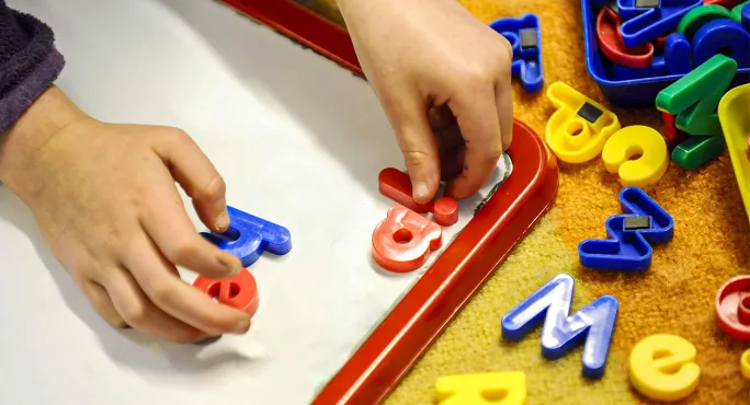 Spelling ia on a child's magnetic board