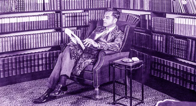 Gentleman quietly reading in an armchair