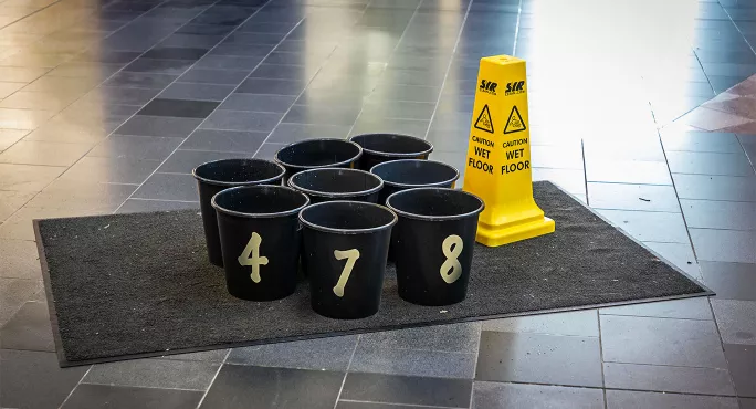 School buildings buckets catching water