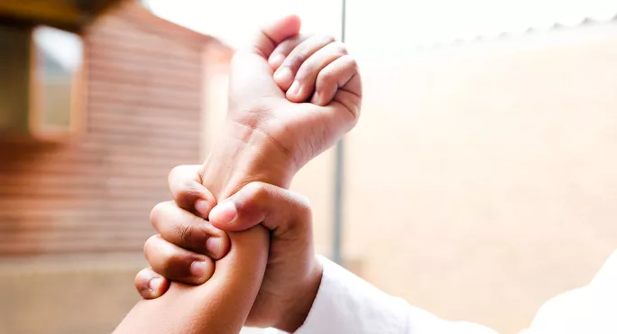 Teacher gripping student's arm