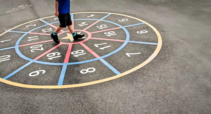 Pupil walking around numbers in playground