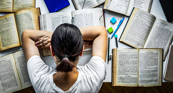 Asleep reading books in library