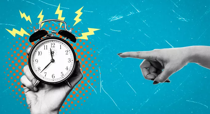 Hand pointing at alarm clock