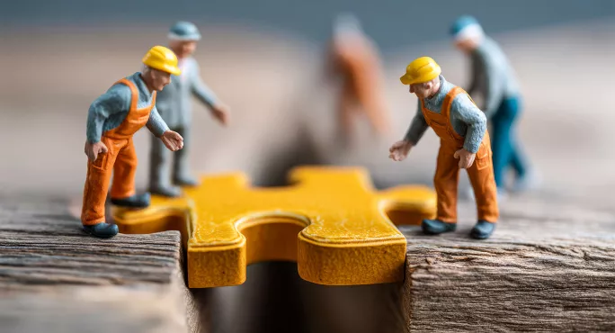 Model figures fixing bridge with jigsaw piece