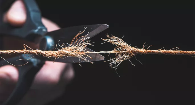 Scissors cutting rope