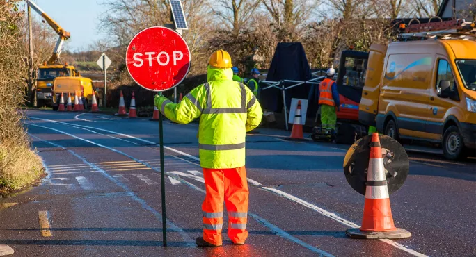 Man holding STOP sign