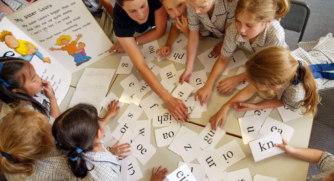 Children with phonics cards