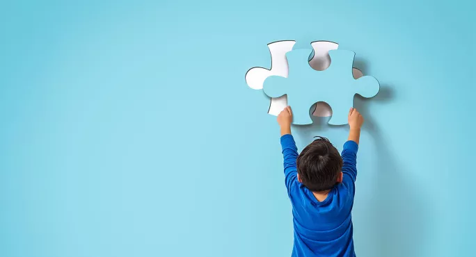 Boy fixing a jigsaw