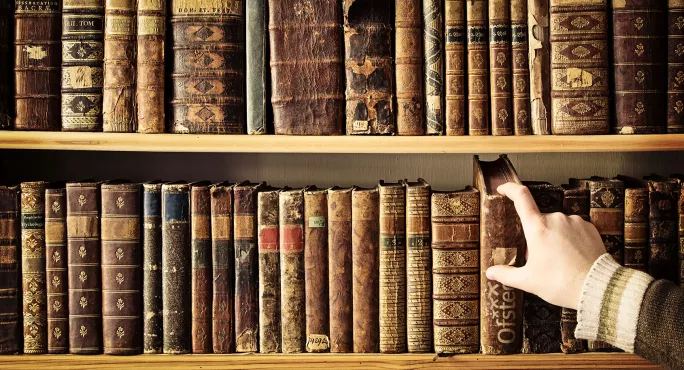 Hand reaching for old book