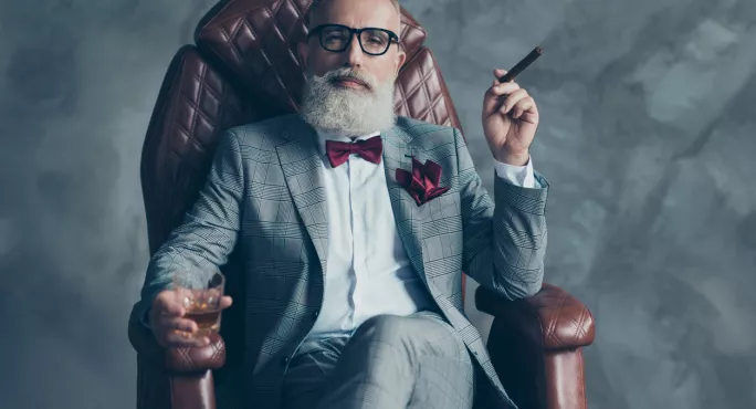 Besuited, Bearded, Bespectacled Man, In Armchair