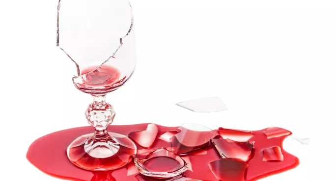 Broken Wine Glass, Surrounded By Puddle Of Red Wine