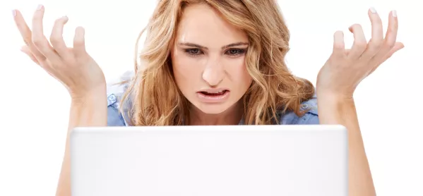 Woman Looks At Computer In Confusion