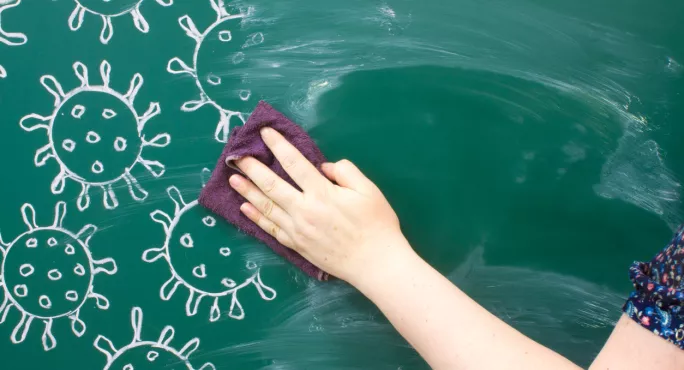 Teacher Wipes Drawing Of Coronavirus Molecules Off Blackboard