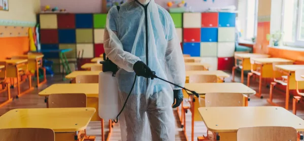 Man In Hazmat Suit Cleans Classroom