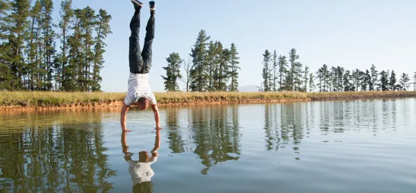 Man Does A Handstand On The Surface Of A Lake