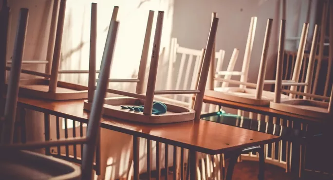 Empty Classroom, With Work Still On Desks