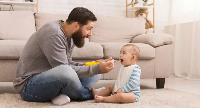 A Father, Spoonfeeding A Baby