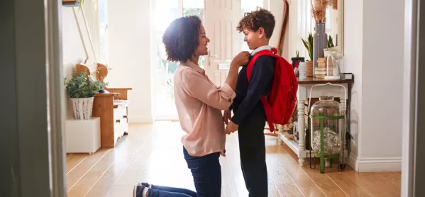 Mother Adjusts Son's Uniform For First Day At New School