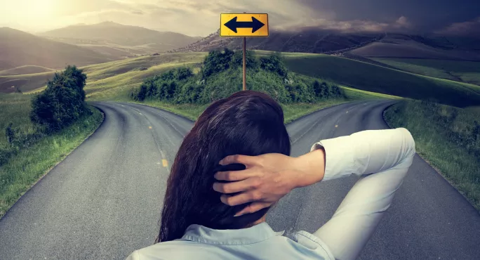 A Woman, Standing Staring At A Fork In The Road