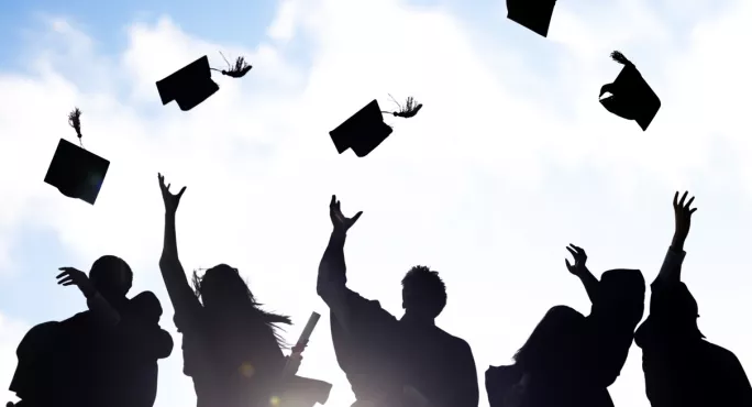 Primary Pupil In Graduation Cap & Gown