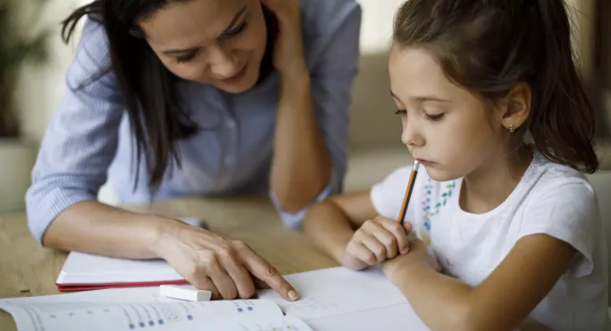 A Teacher Helping A Dyslexic Student